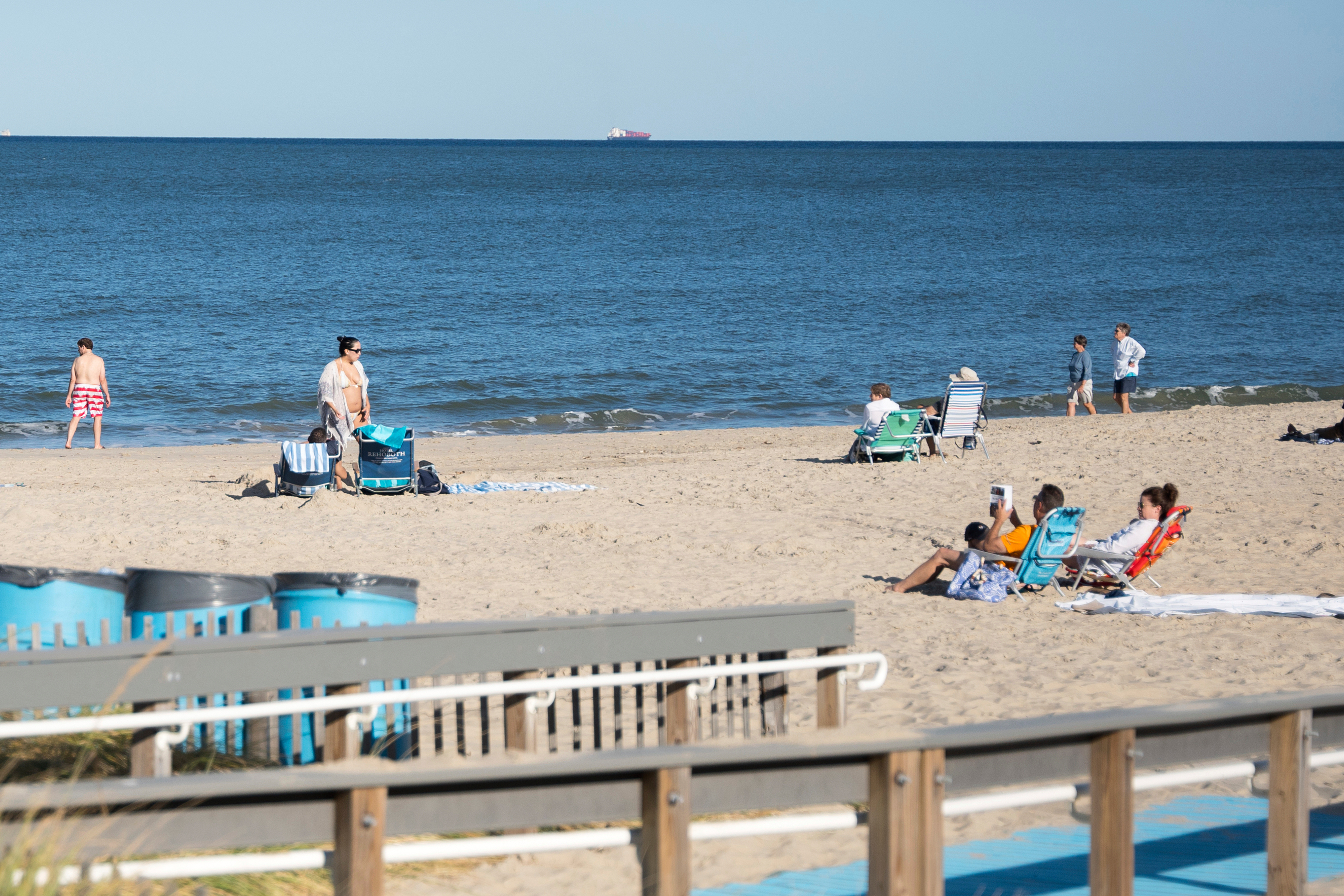 People relax at Rehoboth Beach, Del., on Wednesday, Aug. 27, 2025.