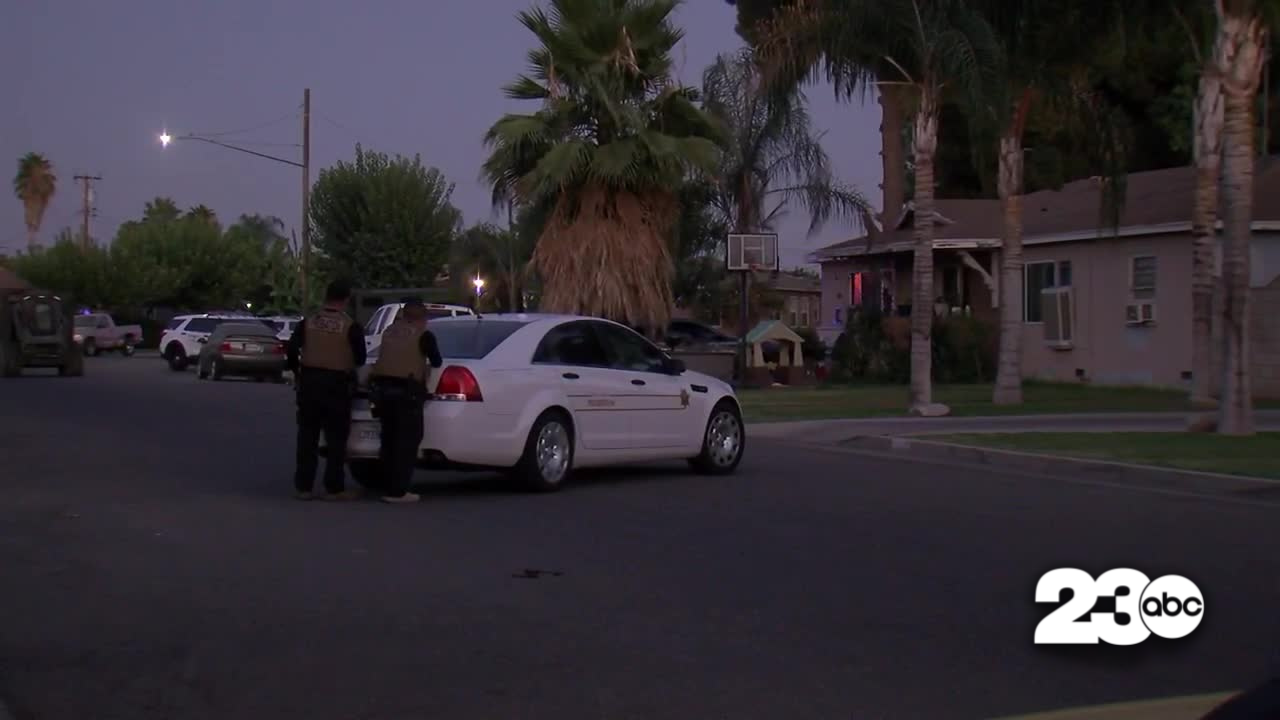 Law enforcement officers stand outside a home in Delano. Officers were in a standoff at the home on Thursday evening.