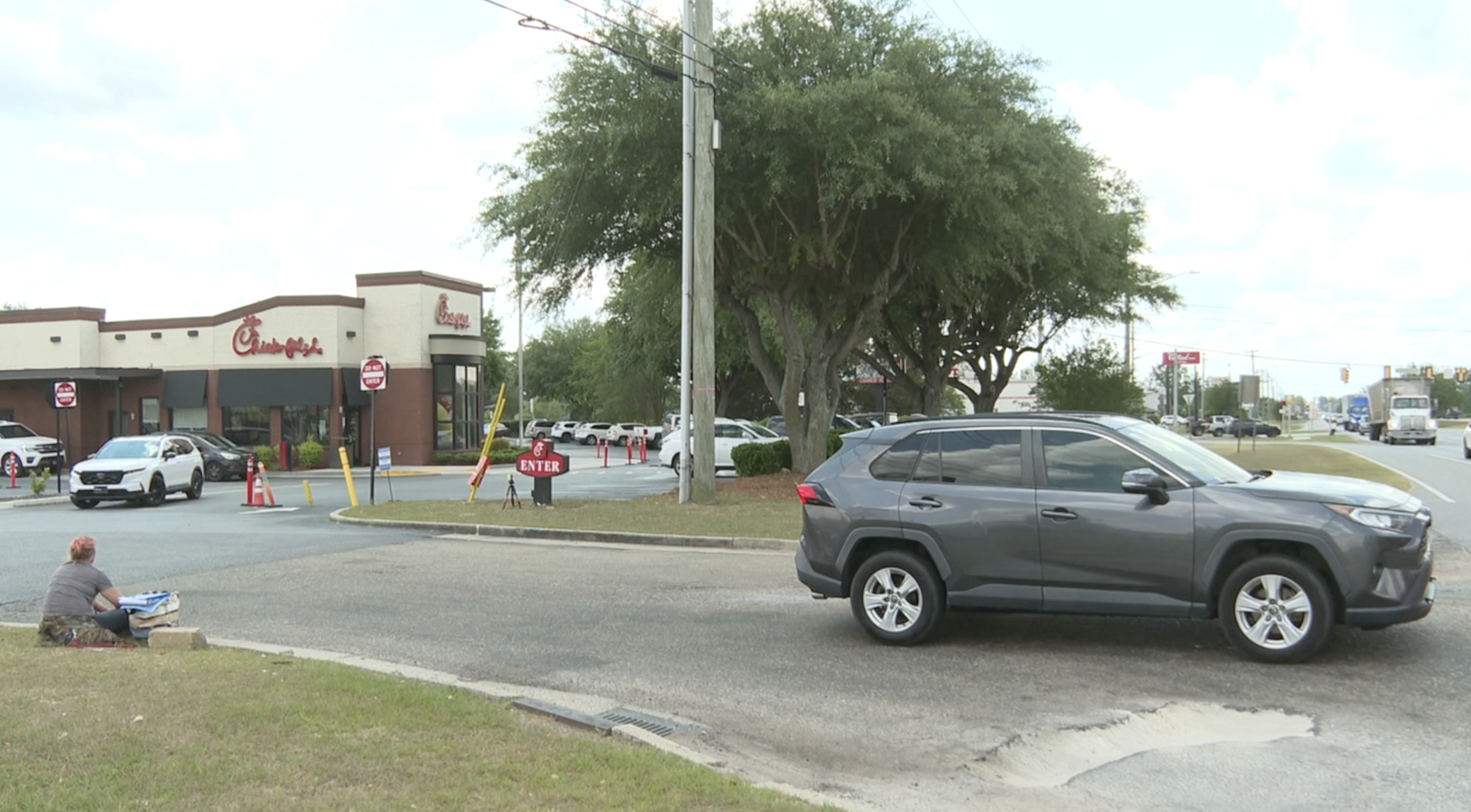 Who is responsible for fixing the dangerous, deep potholes at a Thomasville shopping plaza on US 19?