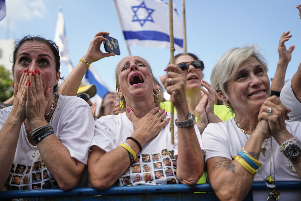 People react as they gather to watch a live broadcast of Israeli hostages released from Gaza at a plaza known as hostages square in Tel Aviv, Israel.