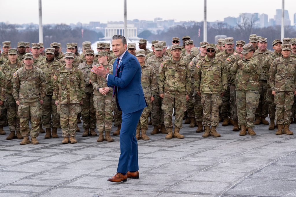Defense Secretary Pete Hegseth claps after administering the oath of enlistment to a group of National Guard soldiers, at the base of the Washington Monument, Friday, Feb. 6, 2026 in Washington. 