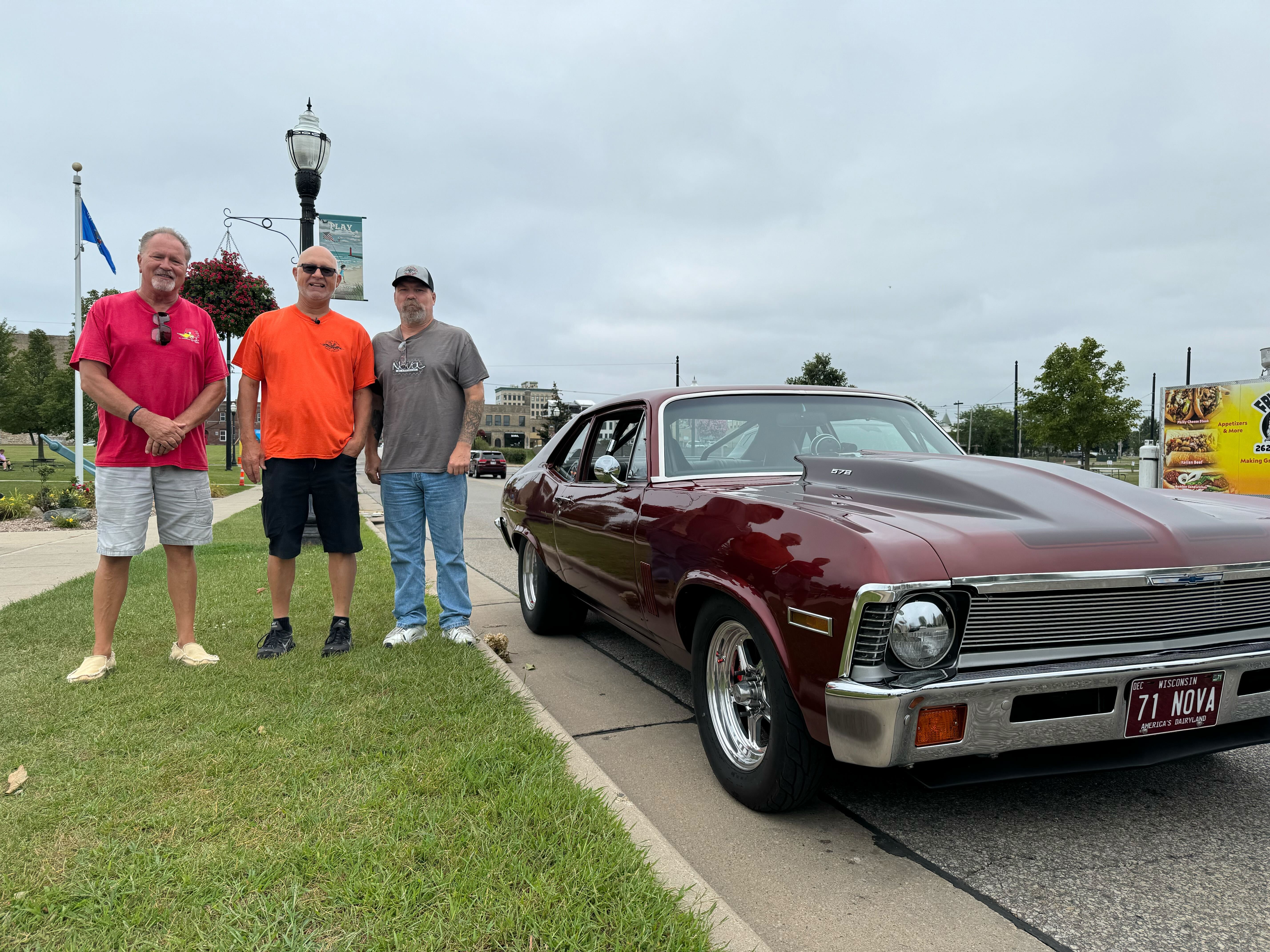 Randy and Mark pose next to a Nova. 