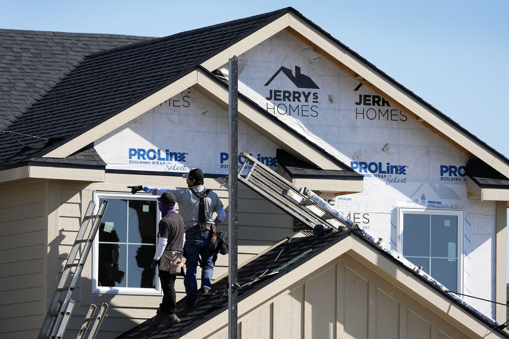 Construction crew members work on a new home build.