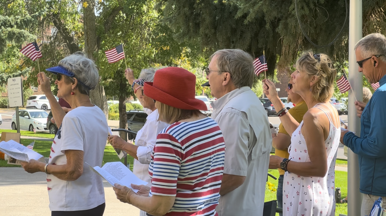 Great Falls residents waving flags at the annual Constitution Day Rally.