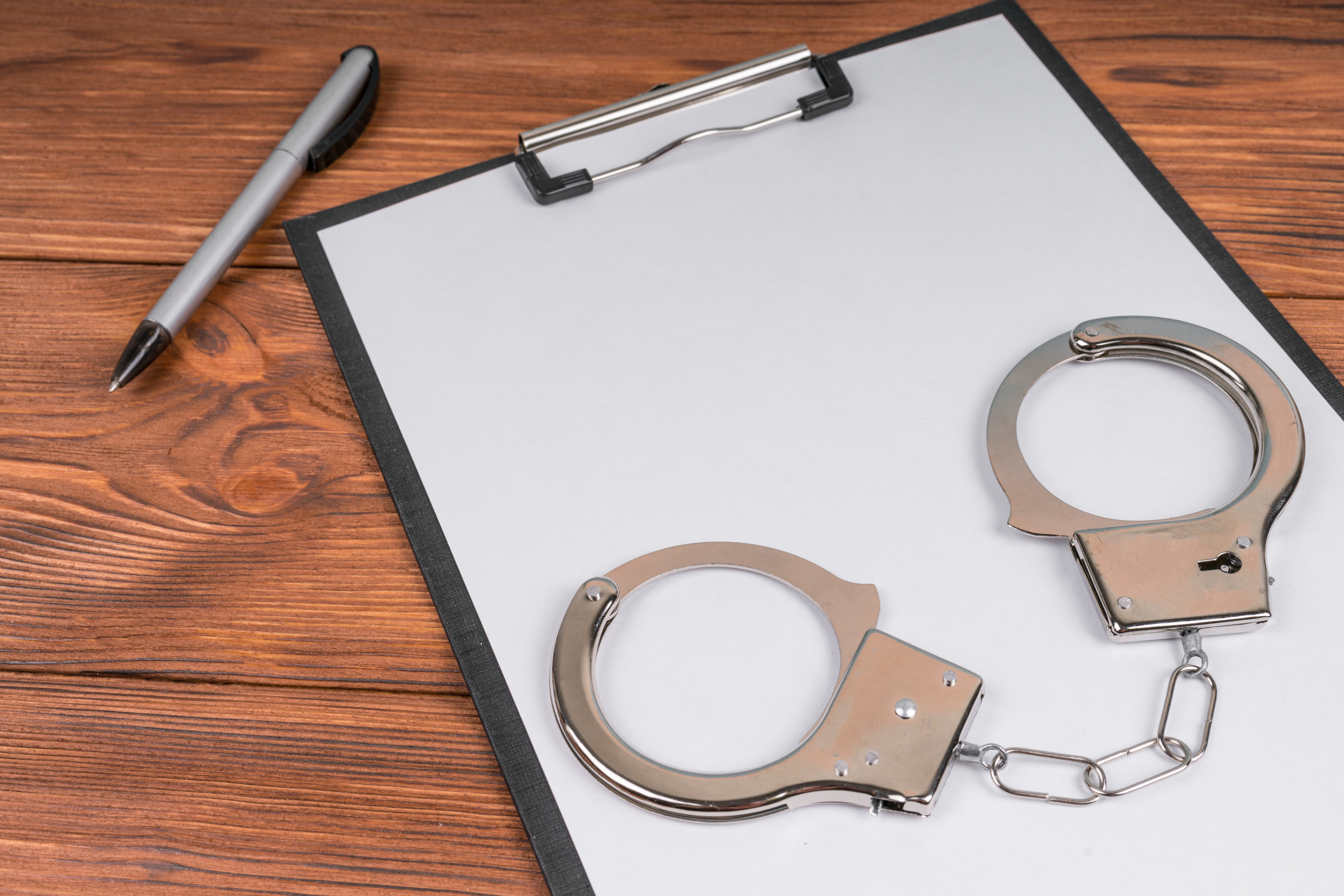 A clipboard and handcuffs