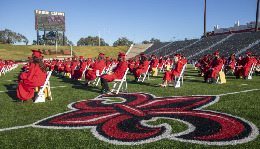 Fall 2020 graduates from the College of Liberal Arts gather Tuesday at Cajun Field for Commencement. The stadium is one of three venues hosting graduation exercises at UL Lafayette. (Photo credit: Rachel Rafati / University of Louisiana at Lafayette)