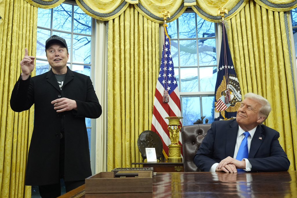 President Donald Trump listens as Elon Musk speaks in the Oval Office at the White House, Feb. 11, 2025, in Washington.