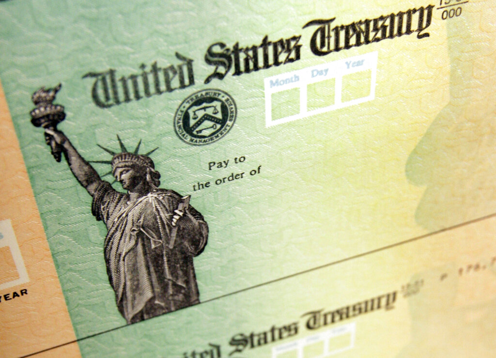 This May 8, 2008, file photo, shows blank checks on an idle press at the Philadelphia Regional Financial Center, which disburses payments on behalf of federal agencies in Philadelphia.