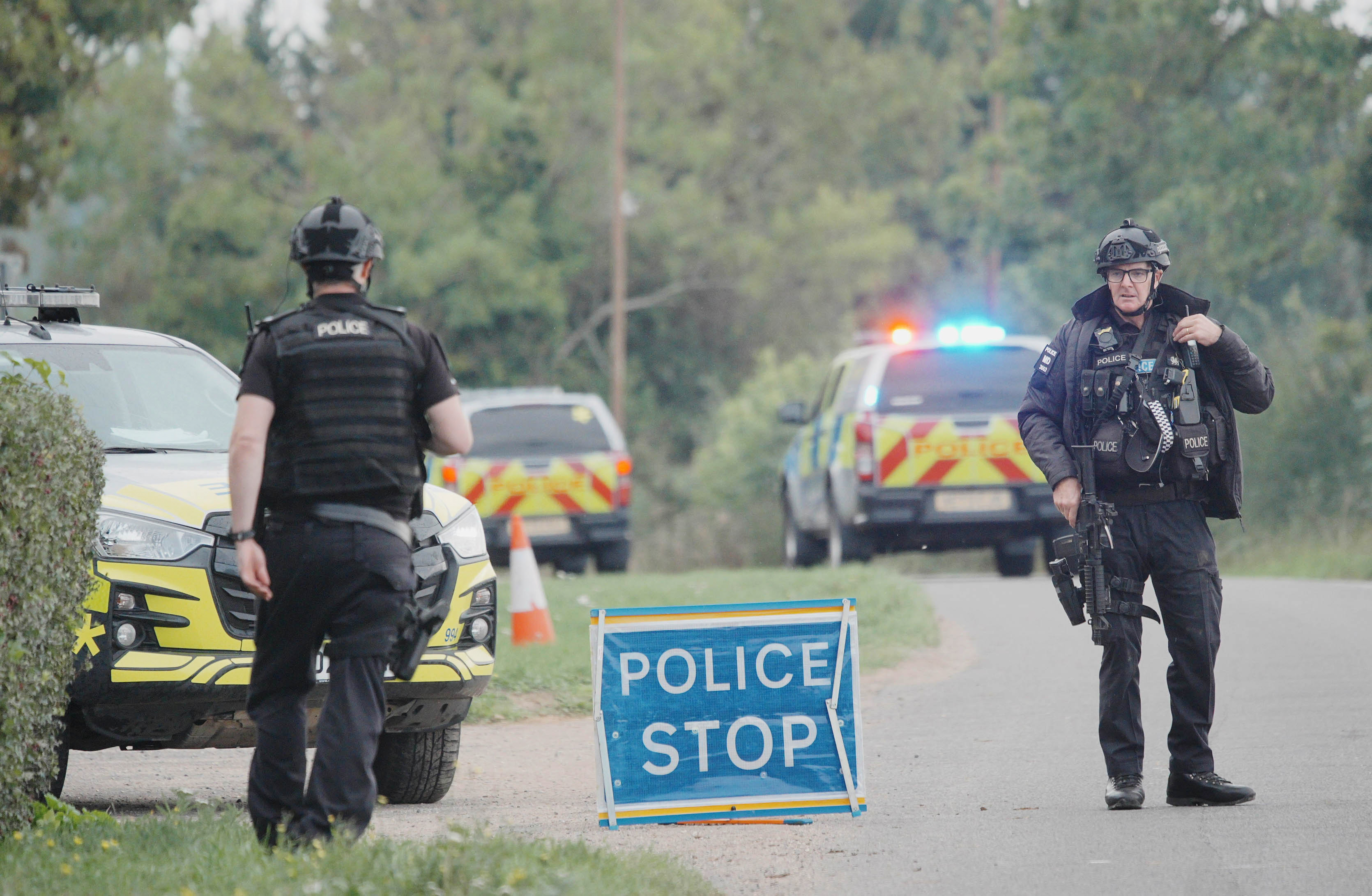 Police stand at a road block on the road to RAF Fairford after an incident, in Whelford, England, Sunday, Sept. 27, 2026.