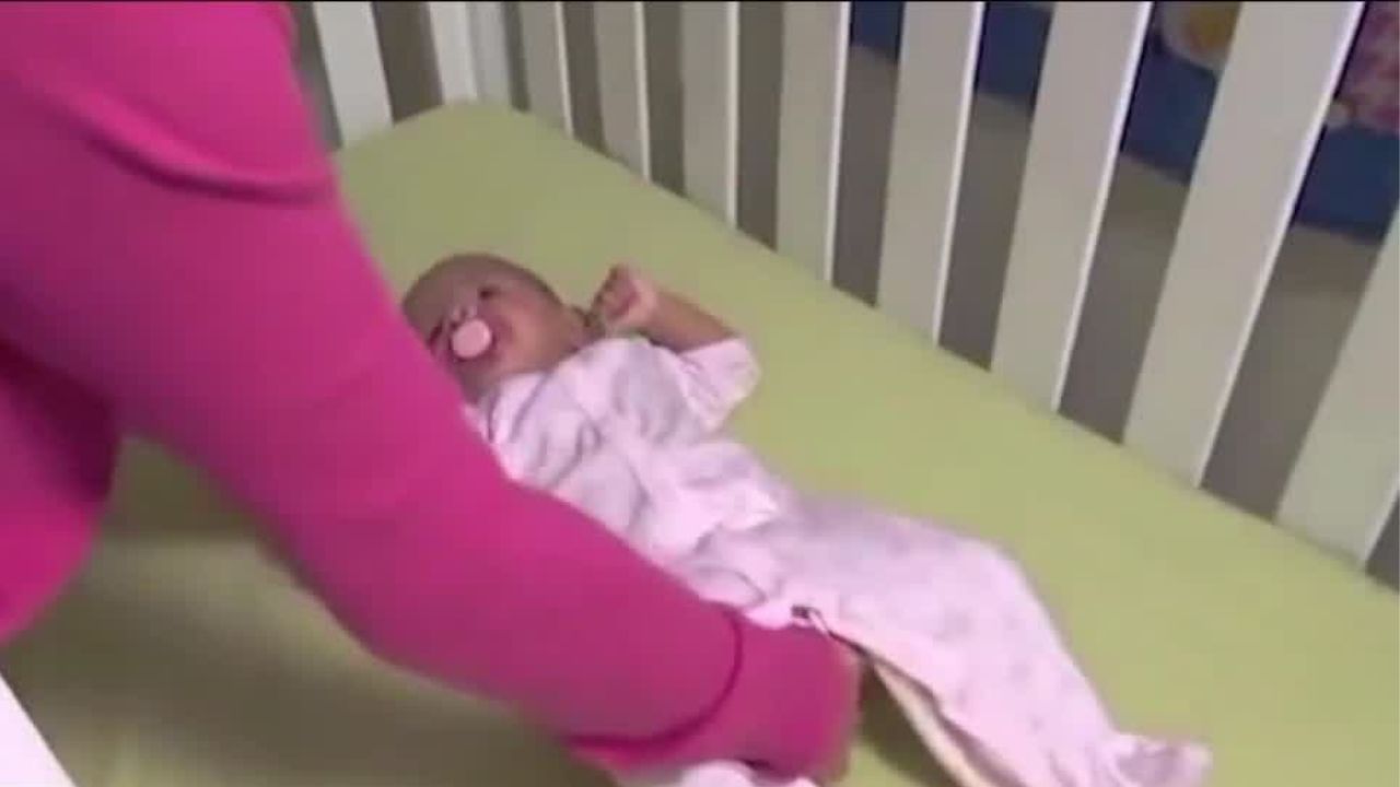 baby being laid on their back to sleep