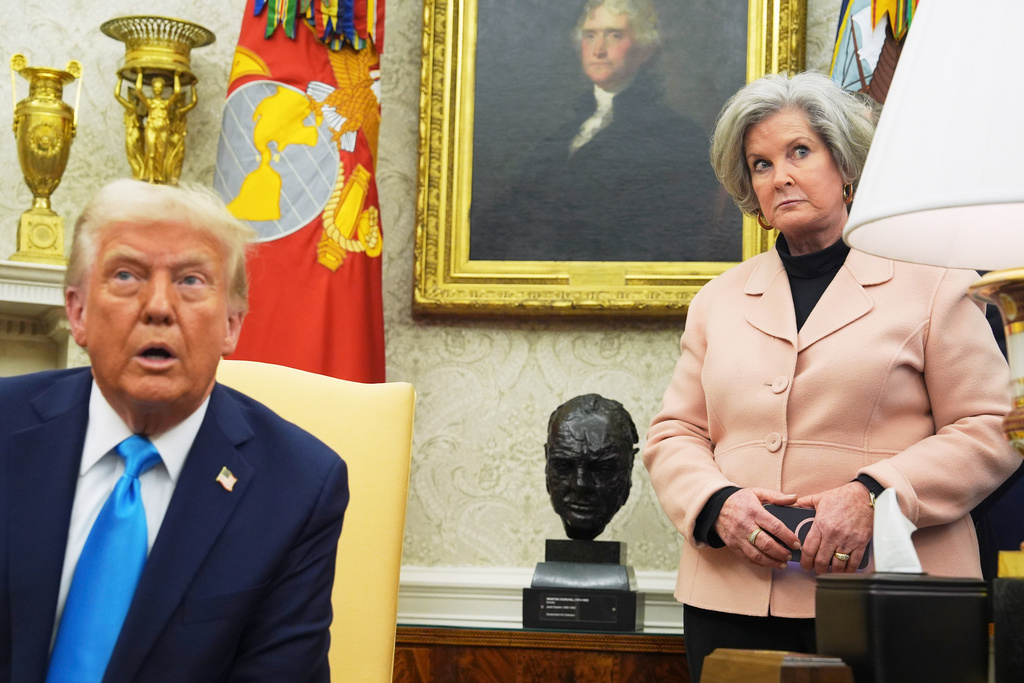 White House chief of staff Susie Wiles listens as President Donald Trump speaks.