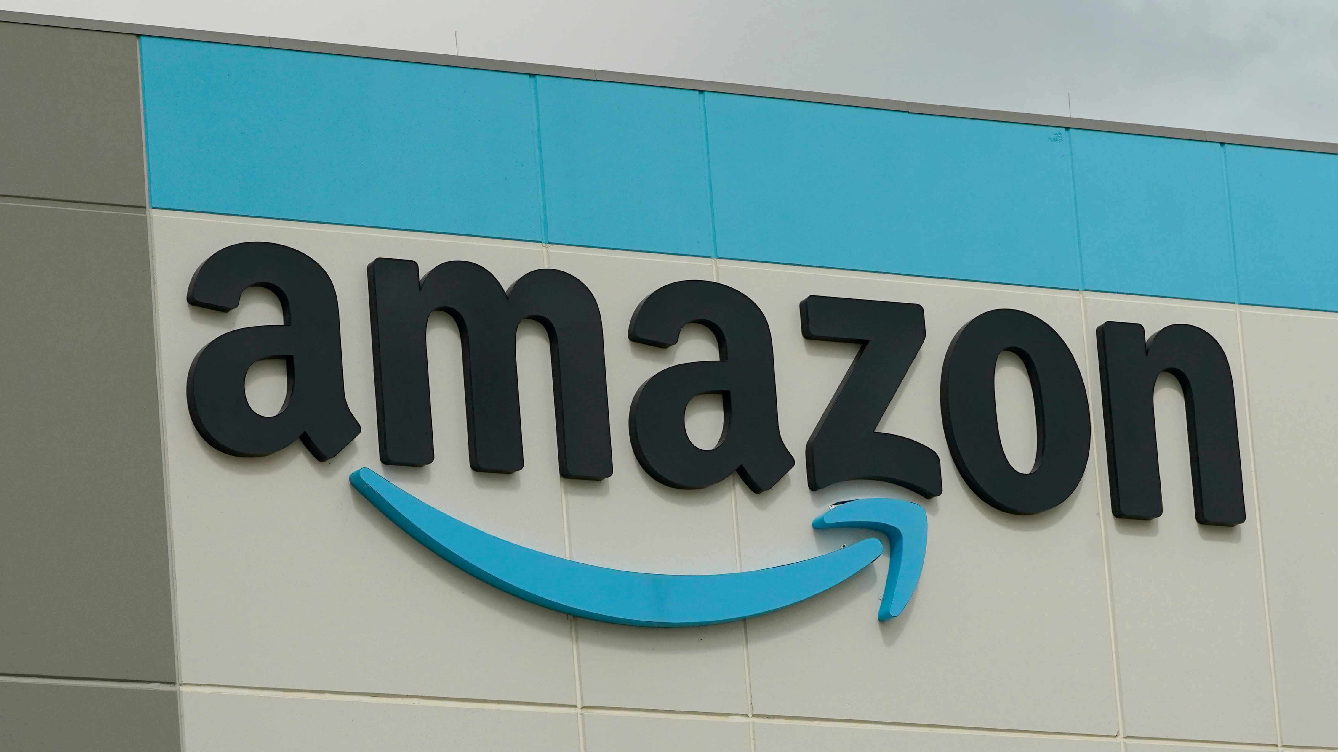 FILE - The Amazon logo is pictured at the Amazon Robotic Sorting Fulfillment Center in Madison County, Miss., Aug. 11, 2022. 