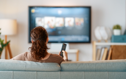 Stock image of a woman watching TV.