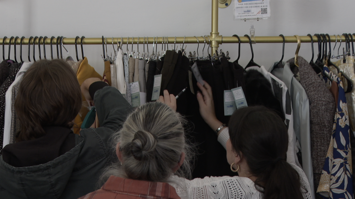 Workers putting price tags on items at Kind Threads in San Marcos. 