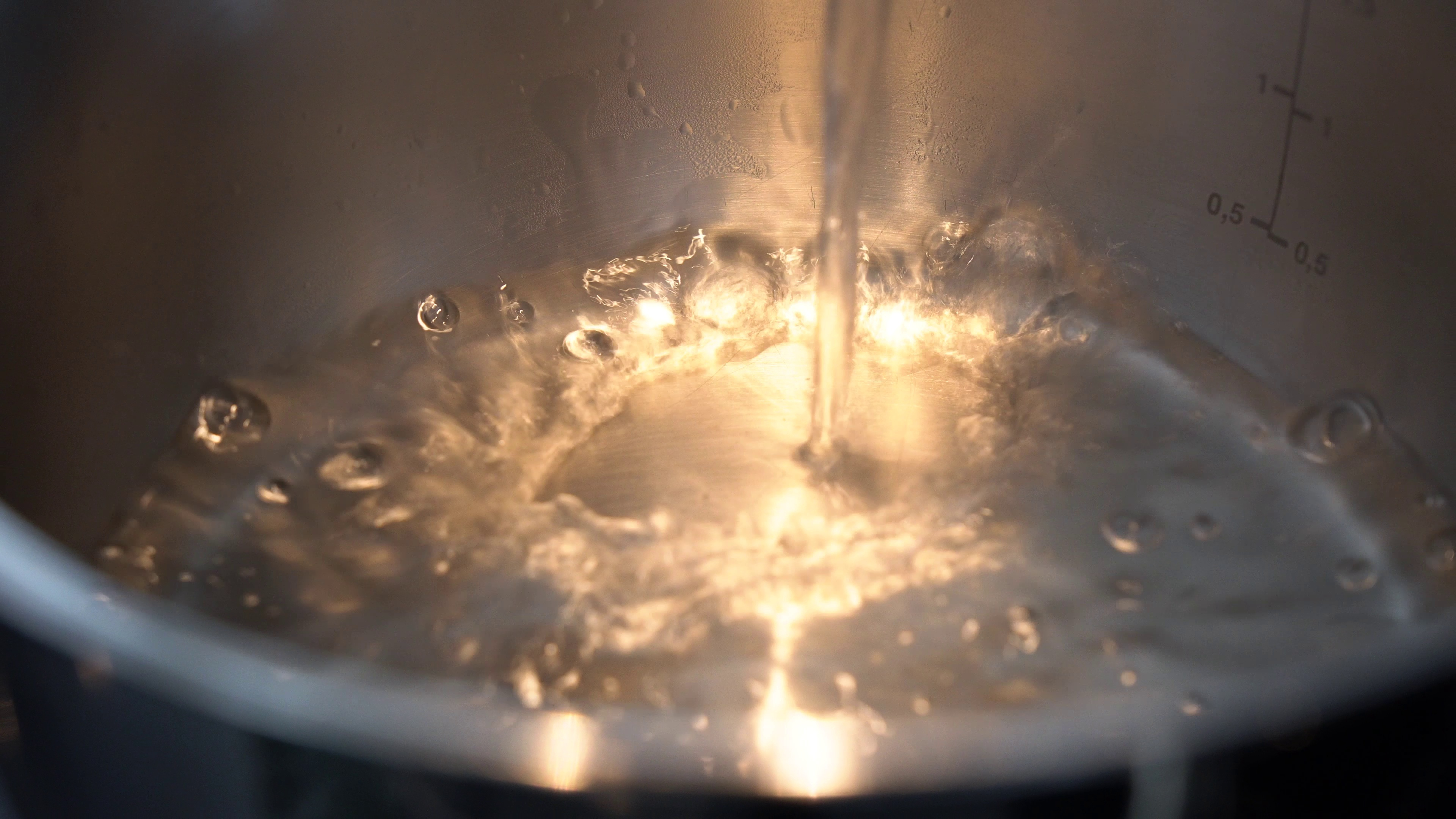 water-is-poured-into-a-pot-closeup