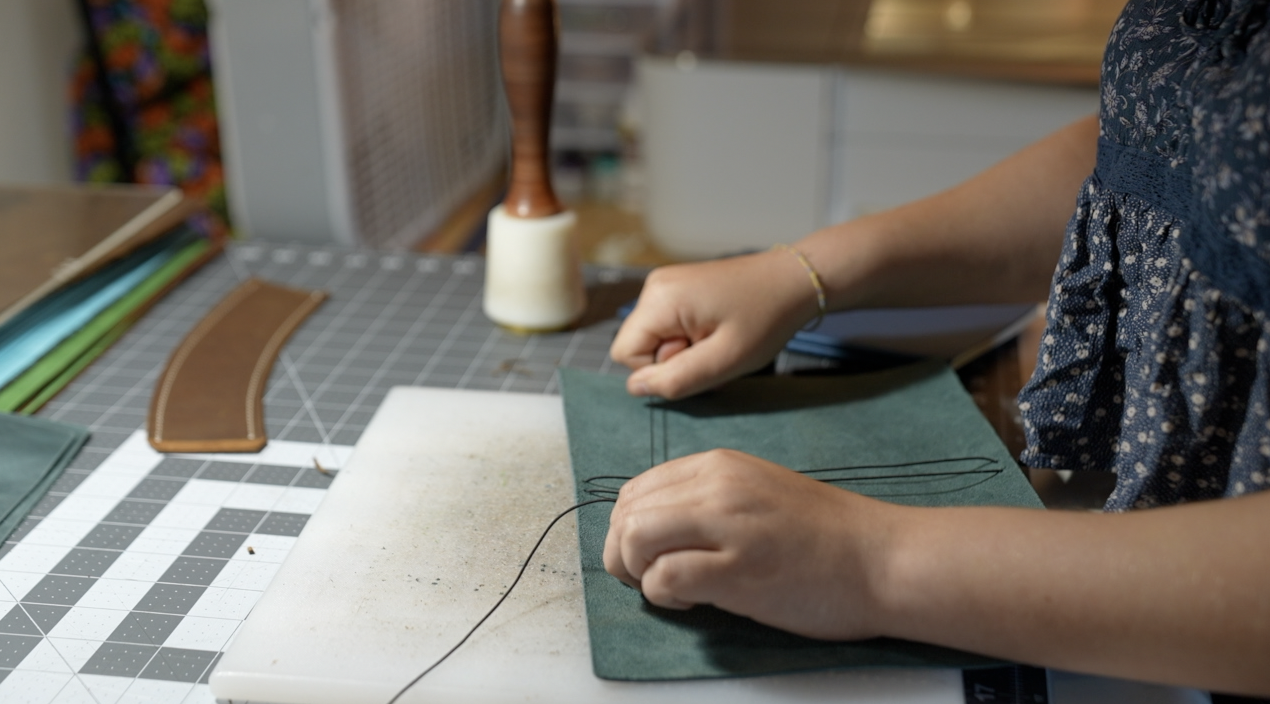 Evelyn ties the string that holds the pages into place
