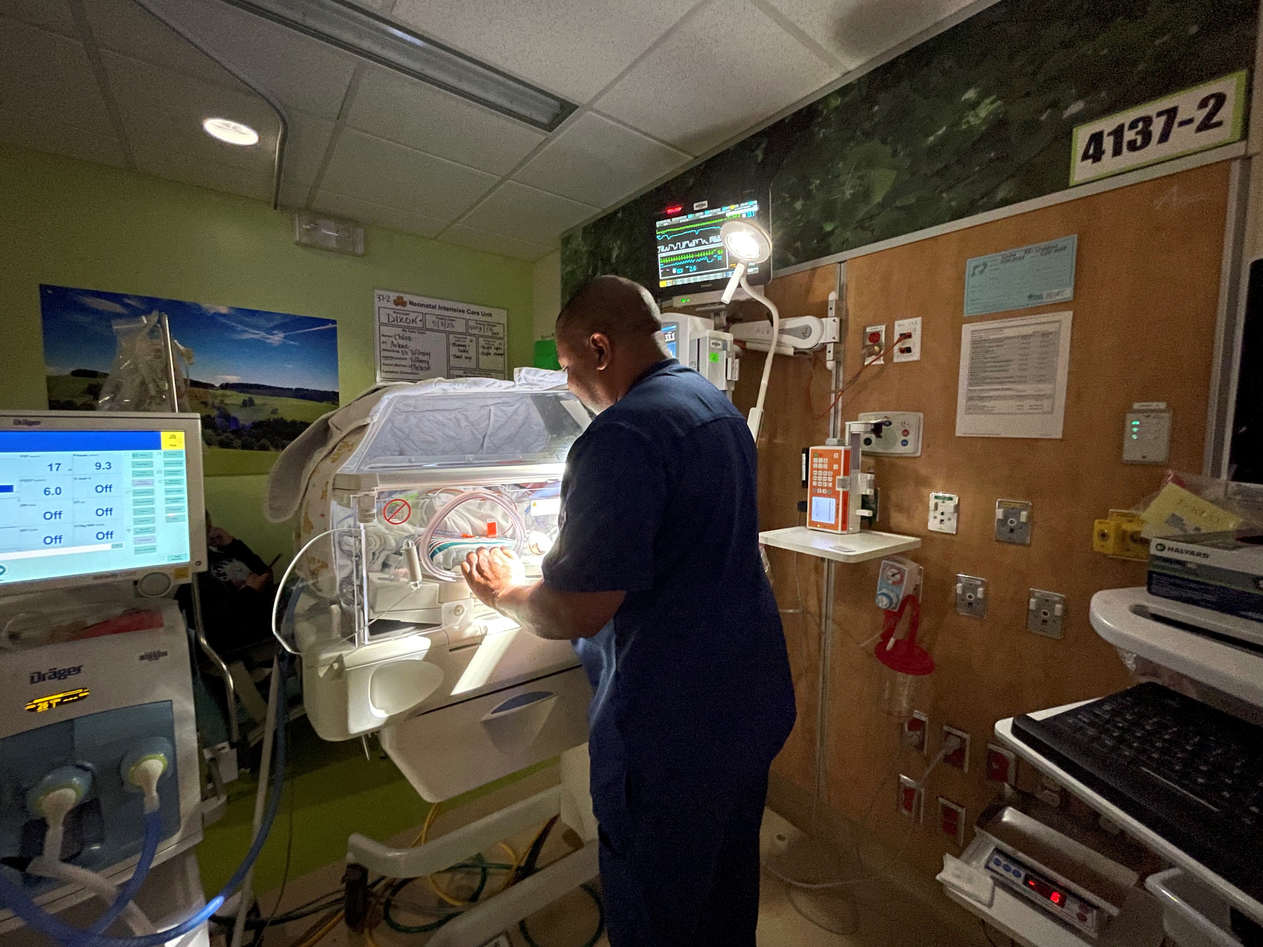 Nurse St. Julien works with NICU patient
