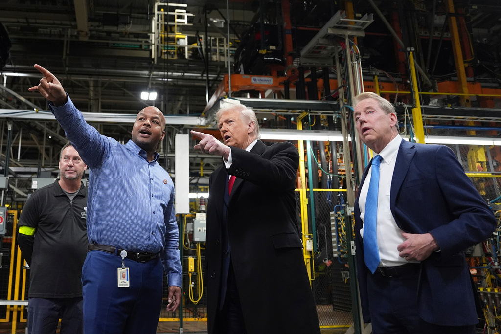President Donald Trump speaks with Corey Williams, Ford River Rouge Plant Manager, during a tour of the Ford River Rogue complex, Tuesday, Jan. 13, 2026, in Dearborn, Mich. At right, Bill Ford, Executive Chairman of Ford, looks on. 