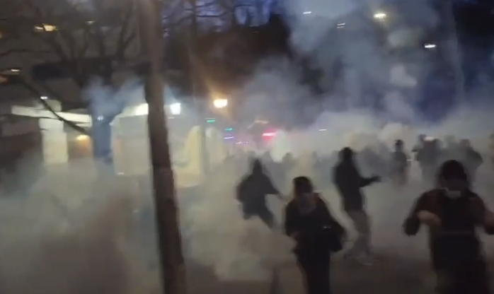 Protesters disperse as federal officials spray an irritant.  