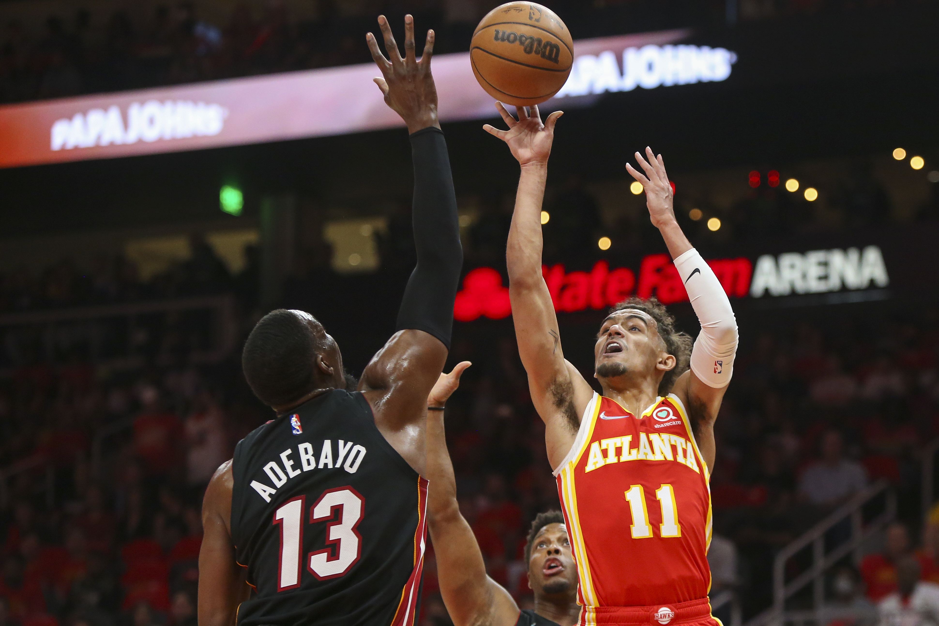 Atlanta Hawks guard Trae Young shoots over Miami Heat center Bam Adebayo, April 22, 2022