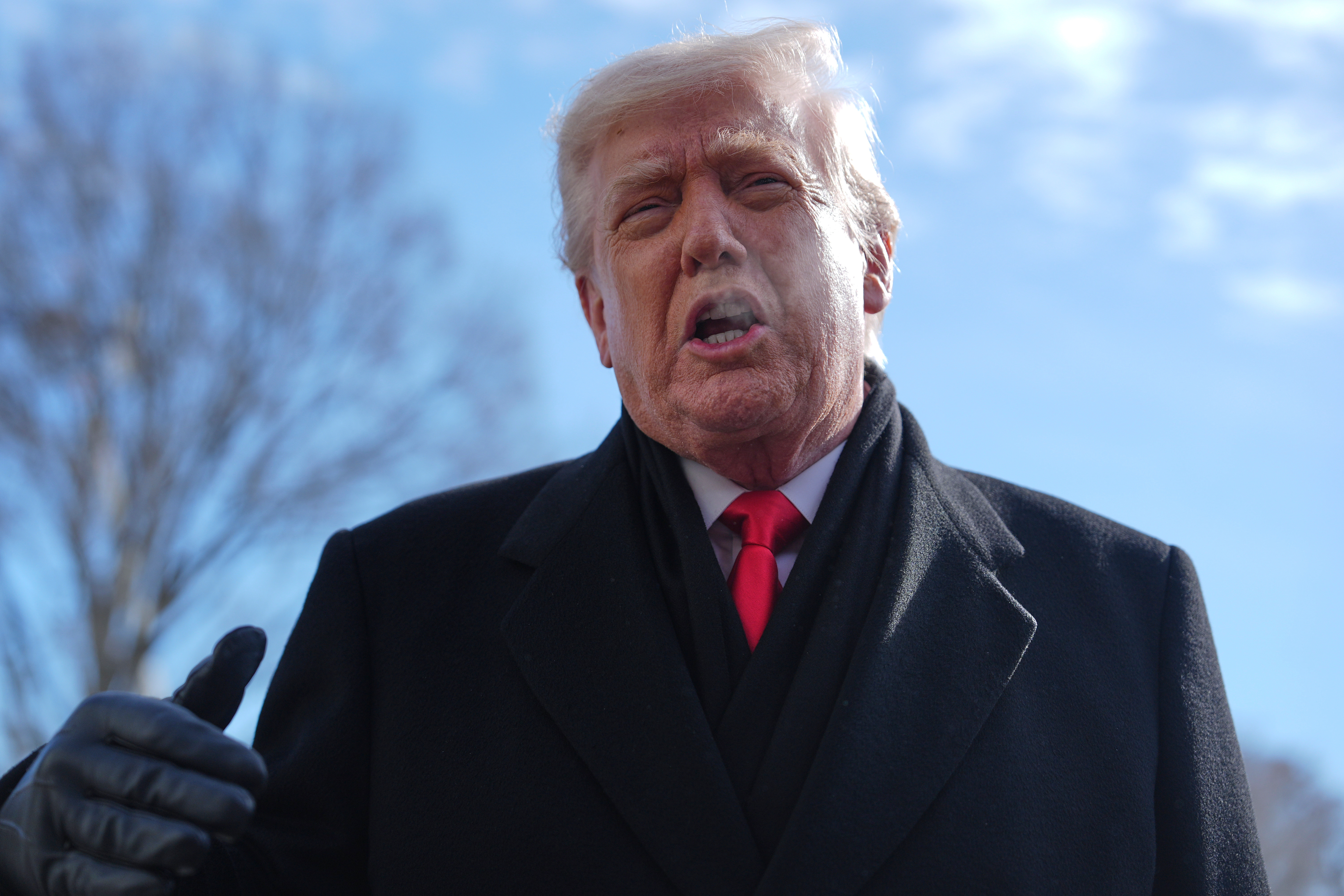 President Donald Trump speaks with reporters before boarding Marine One on South Lawn of the White House, Tuesday, Jan. 27, 2026, in Washington. 