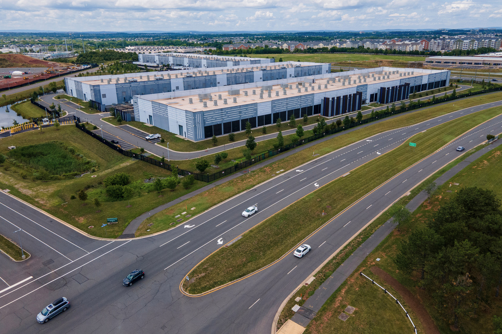 Cars drive past data centers, July 16, 2023, in Ashburn, Va. 