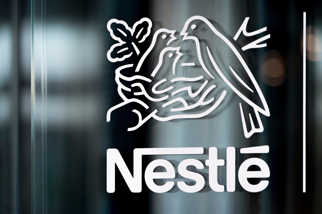 In this Thursday, Feb. 14, 2019, file photo, Nestle's logo is displayed on a window, during the 2018 full-year results press conference of the food and drinks giant Nestle, in Vevey.   