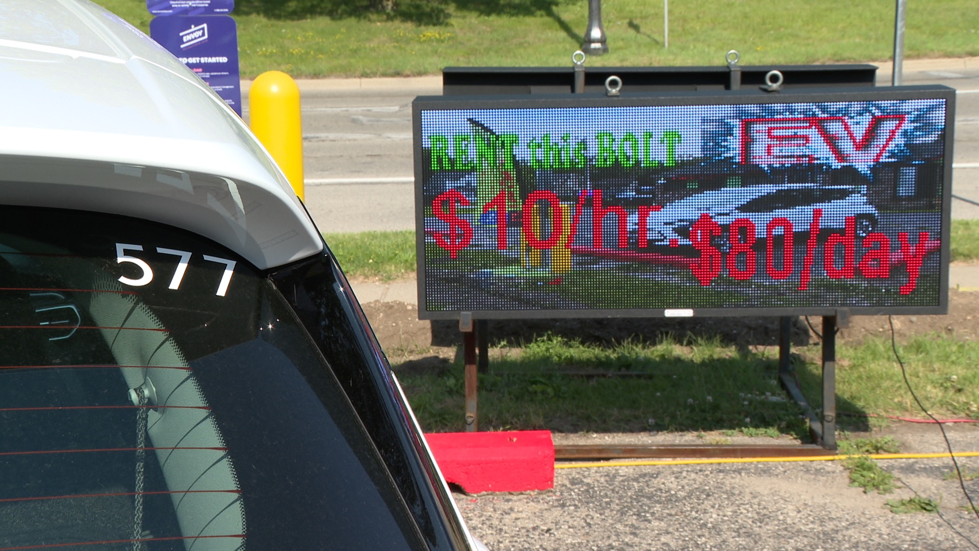 Electric billboard shows Chevy Bolt EV for rent at Evergetic Charging Spa in Lansing