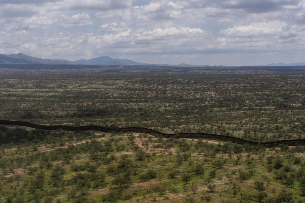 The U.S.-Mexico border fence stretches through remote desert terrain near Nogales, Ariz.