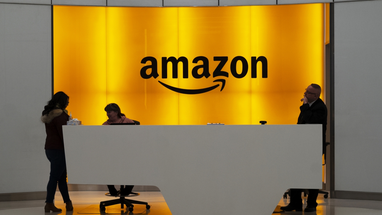 People stand in the lobby for the Amazon offices in New York.