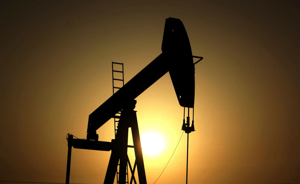  In this Wednesday, June 8, 2011 file photo, sun sets behind an oil pump in the desert oil fields of Sakhir, Bahrain. 