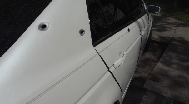 Car with gunshot holes.png