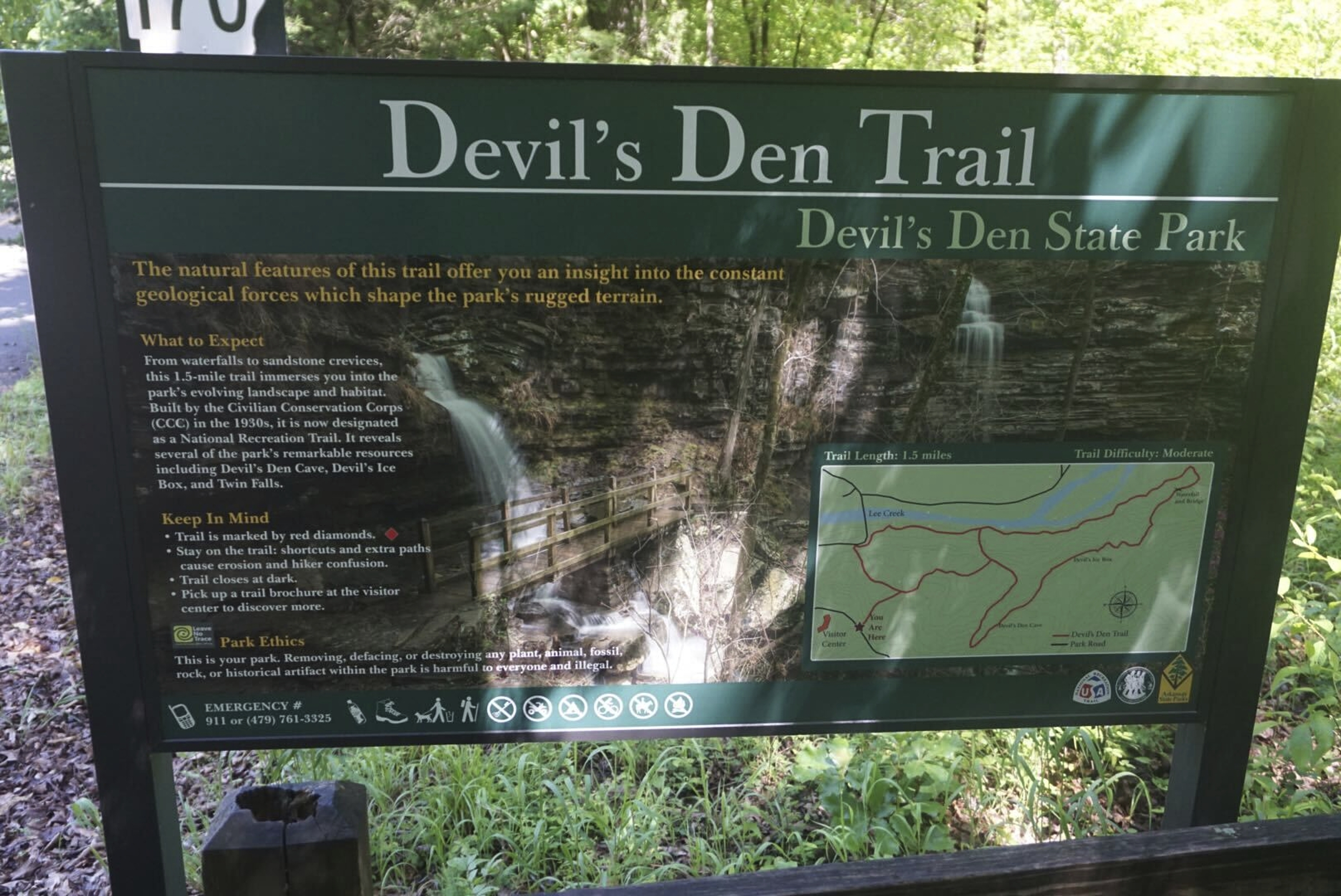 This May 2020 photo provided by Stephen O’Connell shows a sign for a hiking trail at Devil's Den State Park in West Fork, Ark. 