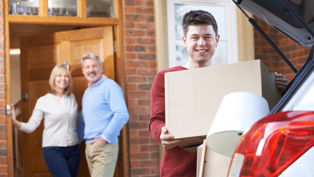 Parents watch as their child packs for college.