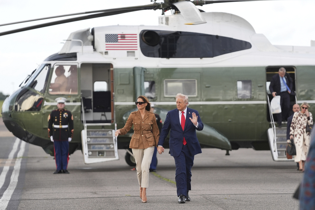 President Donald Trump and first lady Melania Trump wave after arriving on Marine One at Stansted Airport, Thursday, Sept. 18, 2025, in Stansted, England. 