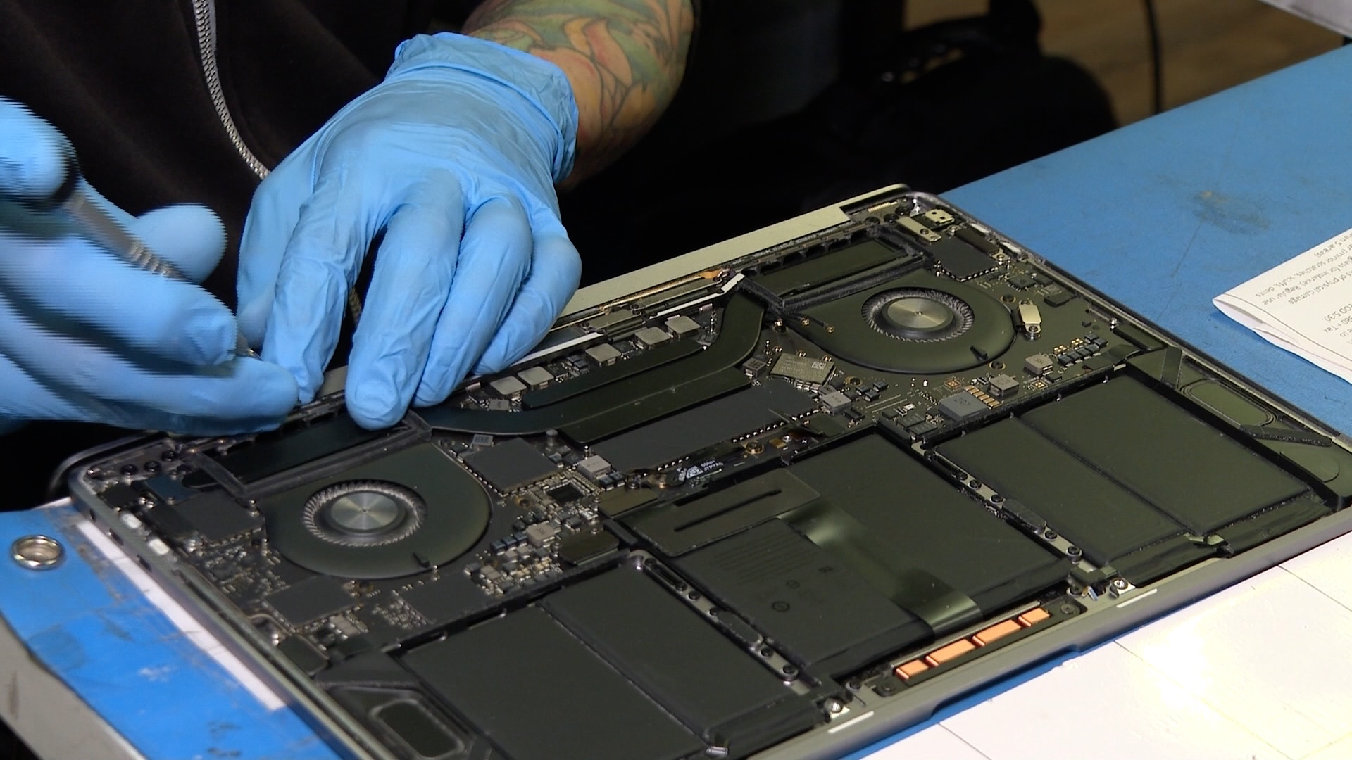 Man fixing computer at electronics repair shop