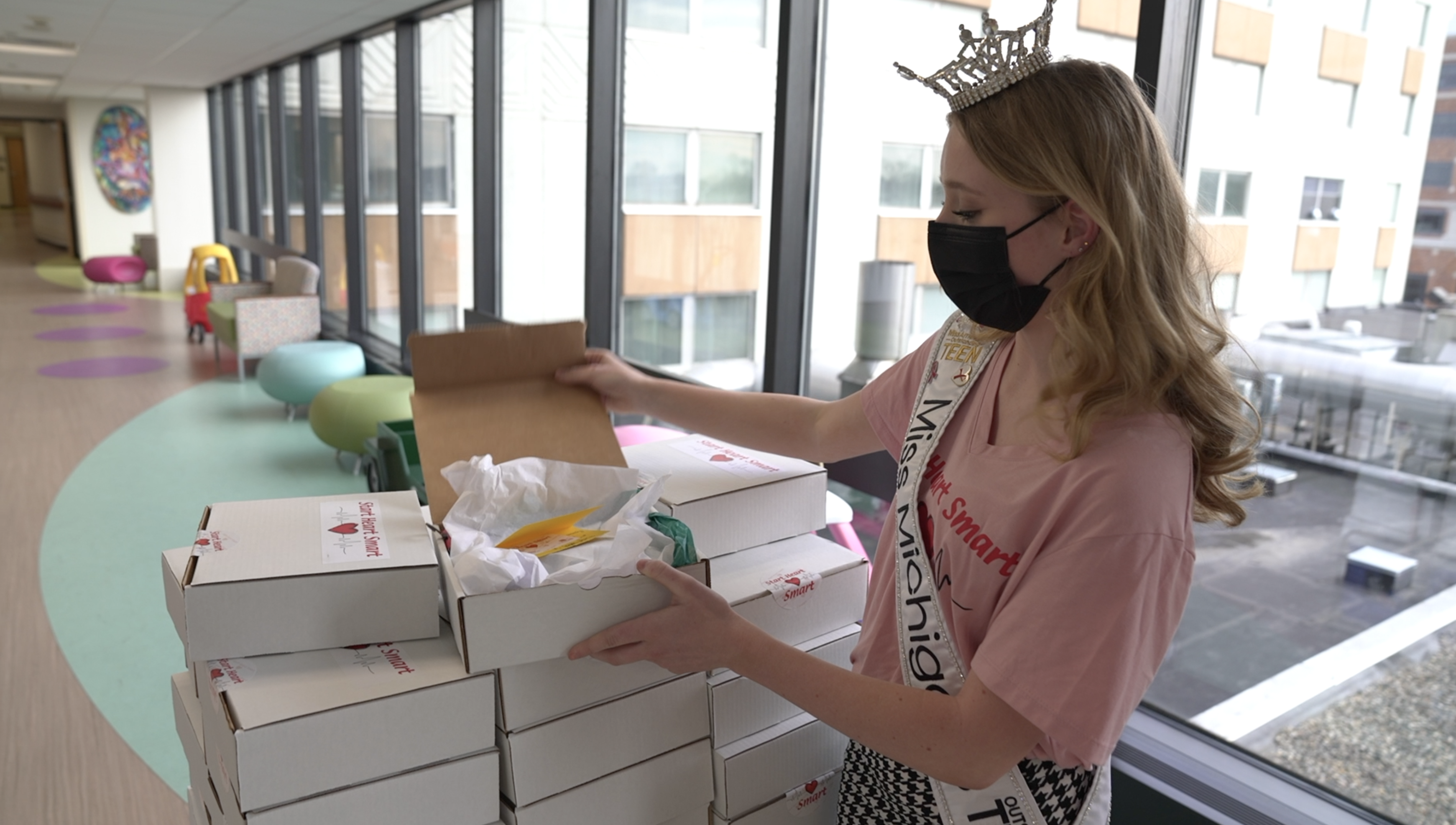 Miss Michigan's Outstanding Teen showing off her care packages 