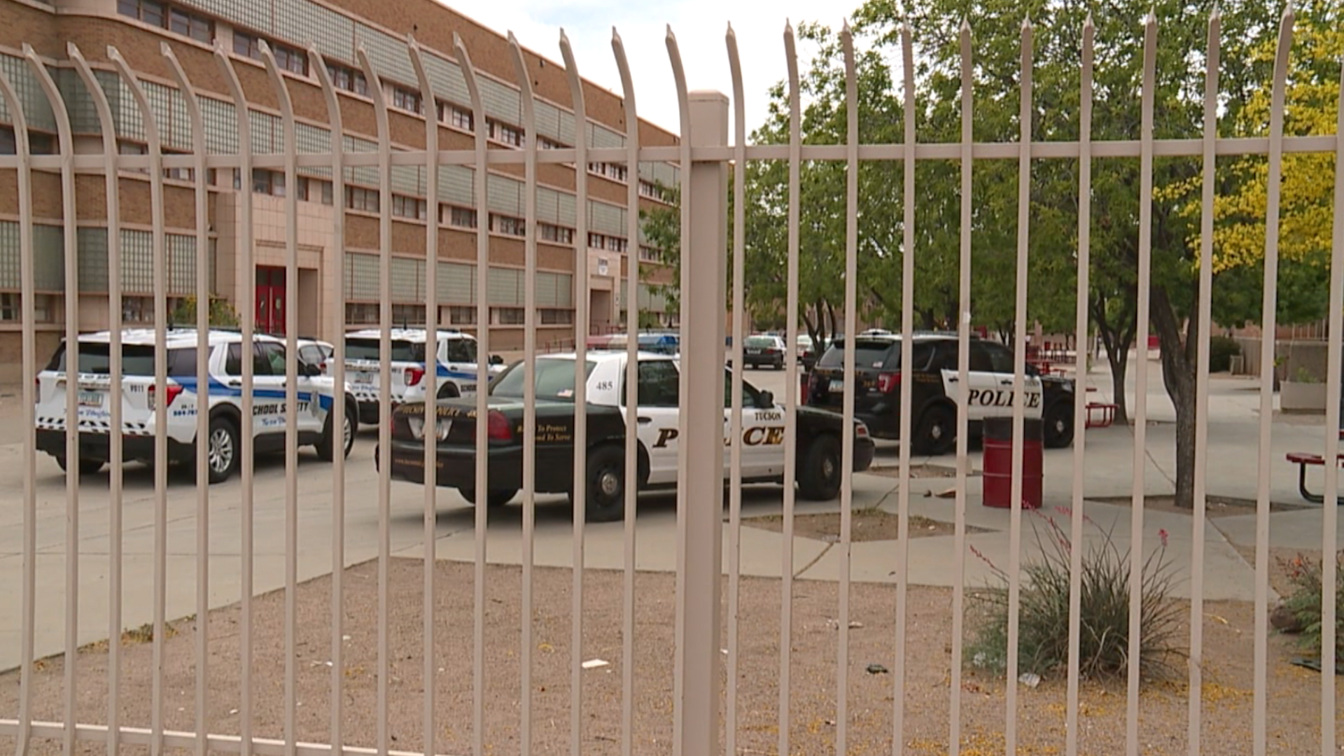 Tucson Police and TUSD security vehicles in the courtyard area of Tucson High School.