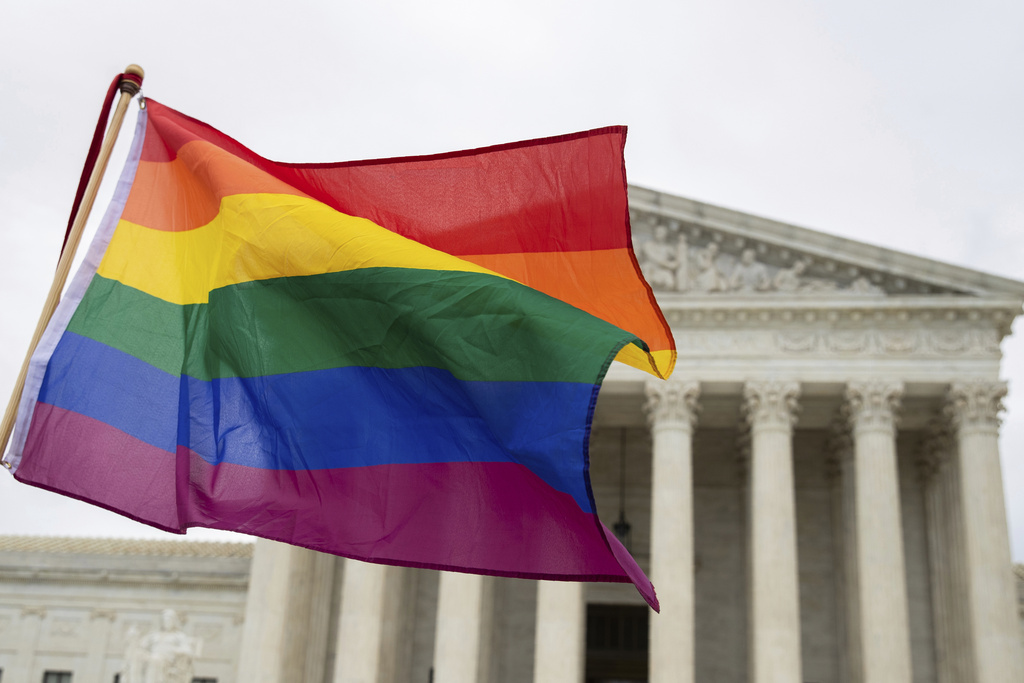 A pride flag is seen in front of the U.S. Supreme Court.