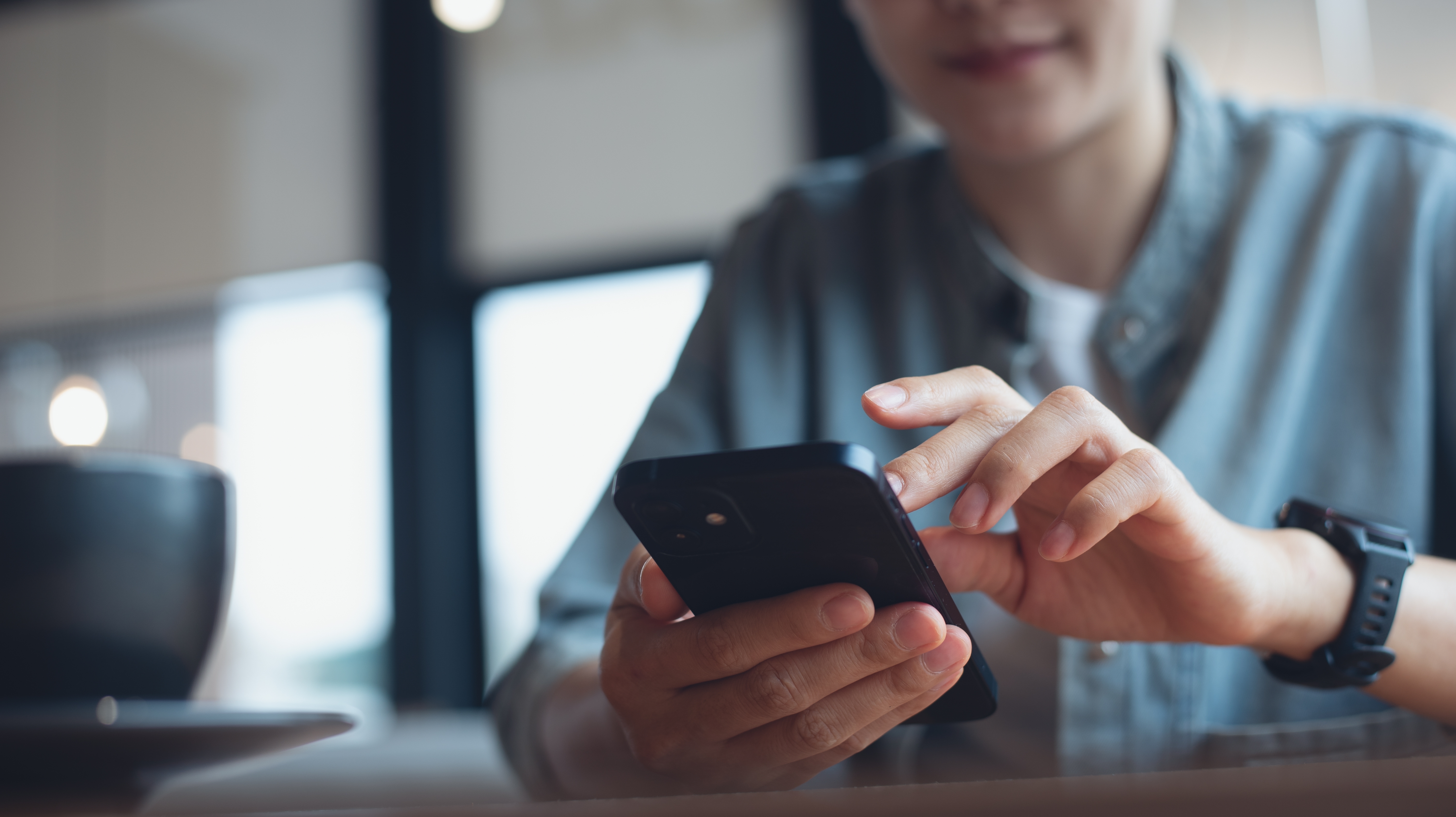 Close up of a person using a smartphone.