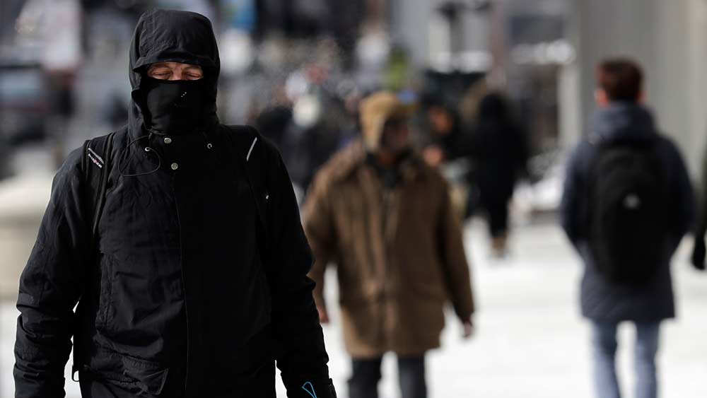 A man is bundled up against the cold in downtown Chicago, Sunday, Jan. 27, 2019. More than with many snowstorms Chicagoans have endured in recent history, where you live will greatly impact how much snow you arise to Monday morning, forecasters said. (AP Photo/Nam Y. Huh)
