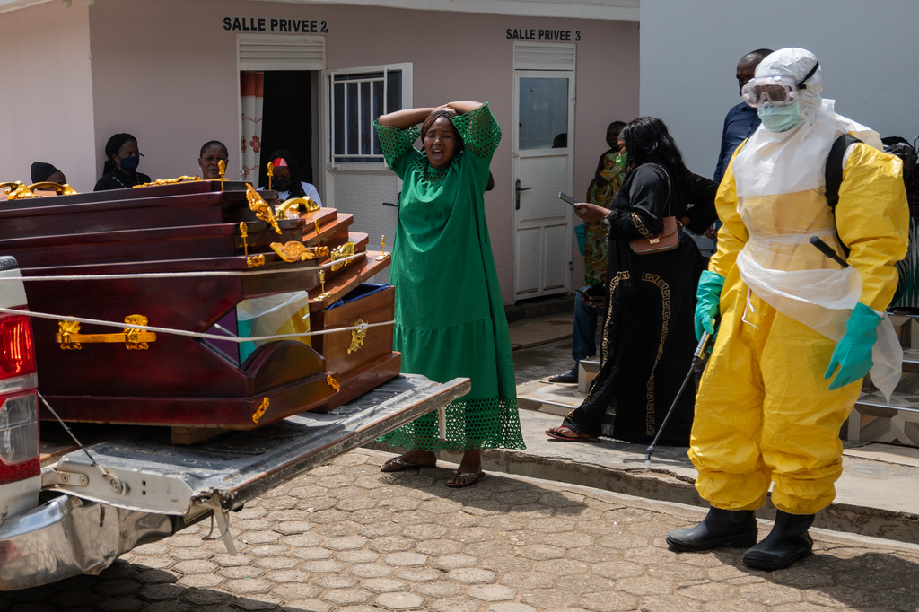 A woman mourns an Ebola victim as the coffin is take away for burial, at Sofepadi Hospital in Bunia, Congo, Saturday, May 23, 2026.