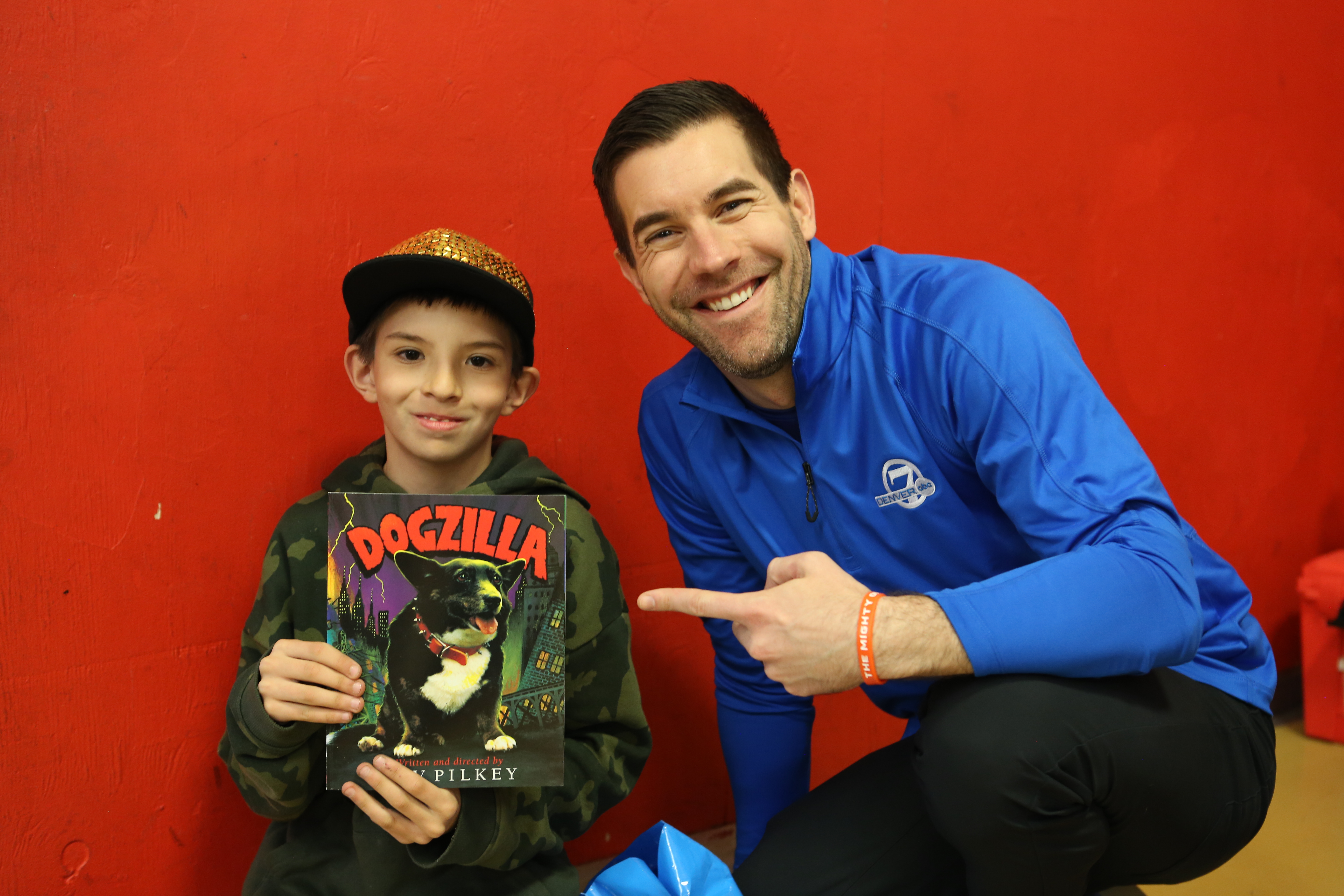 jason g give a child a book.JPG