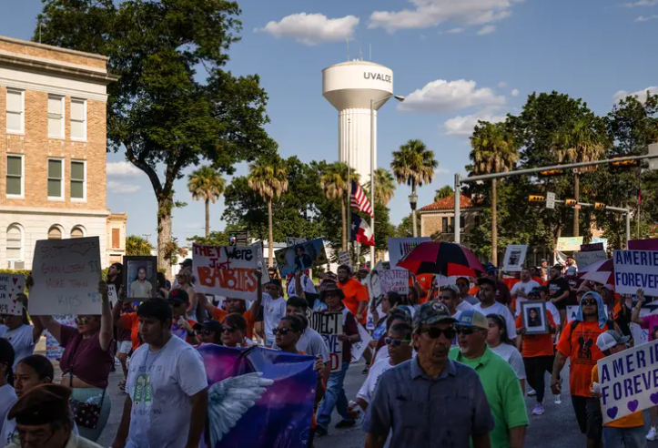 Family members and friends participate in a march in support of those killed and injured in the school shooting at Robb Elementary, in Uvalde on July 10, 2022.