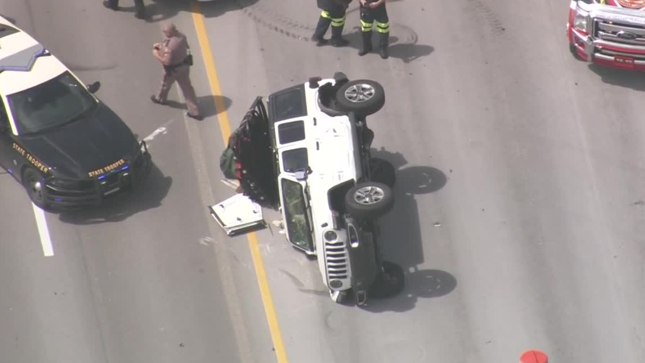 Aerial closeup of Jeep on its side after police chase ends on I-95 in Deerfield Beach