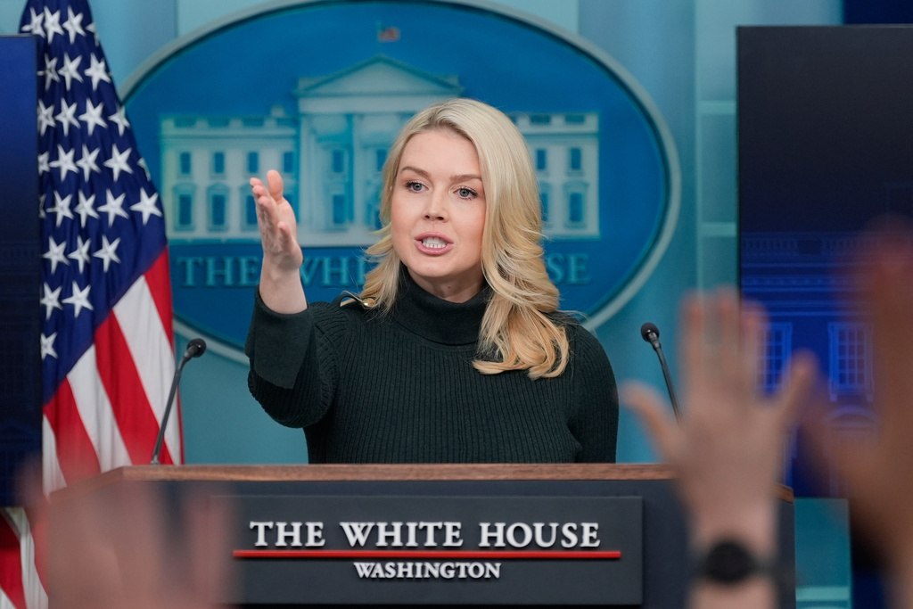 Reporters raise their hands to ask a question as White House press secretary Karoline Leavitt speaks with reporters in the James Brady Press Briefing Room at the White House, Monday, Jan. 26, 2026, in Washington. 