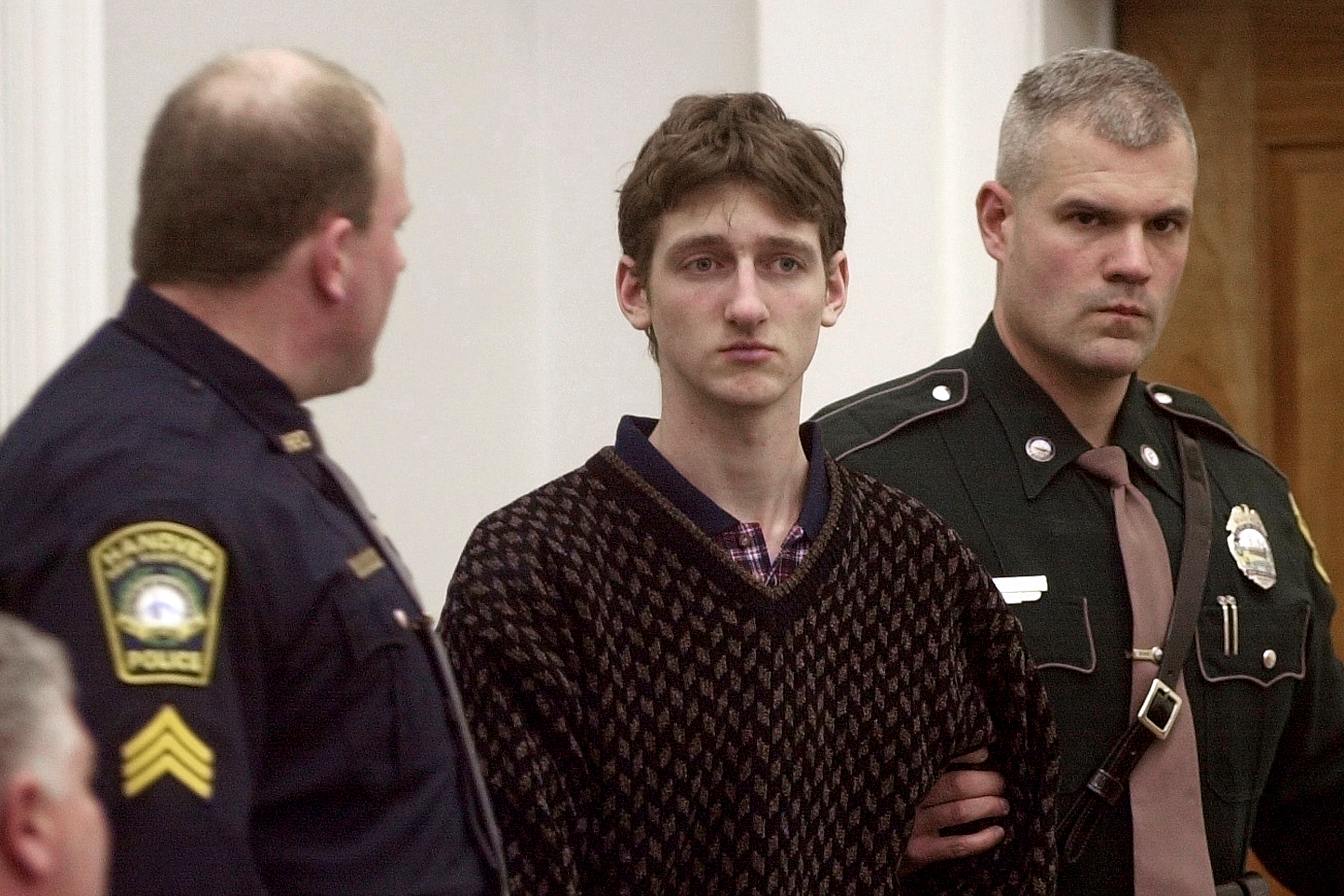 FILE - Robert Tulloch, 17, is escorted into Lebanon, N.H. District Court by Tropper James Stienmetz, right, and Hanover Sgt. Jeffrey Fleury, Feb. 21, 2001. 
