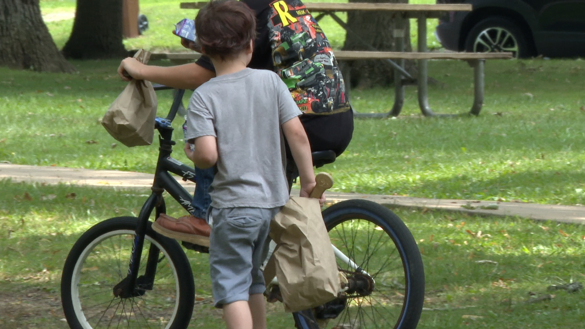 Kids carry summer lunches from Meet Up & Eat Up program at Oak Park in Charlotte