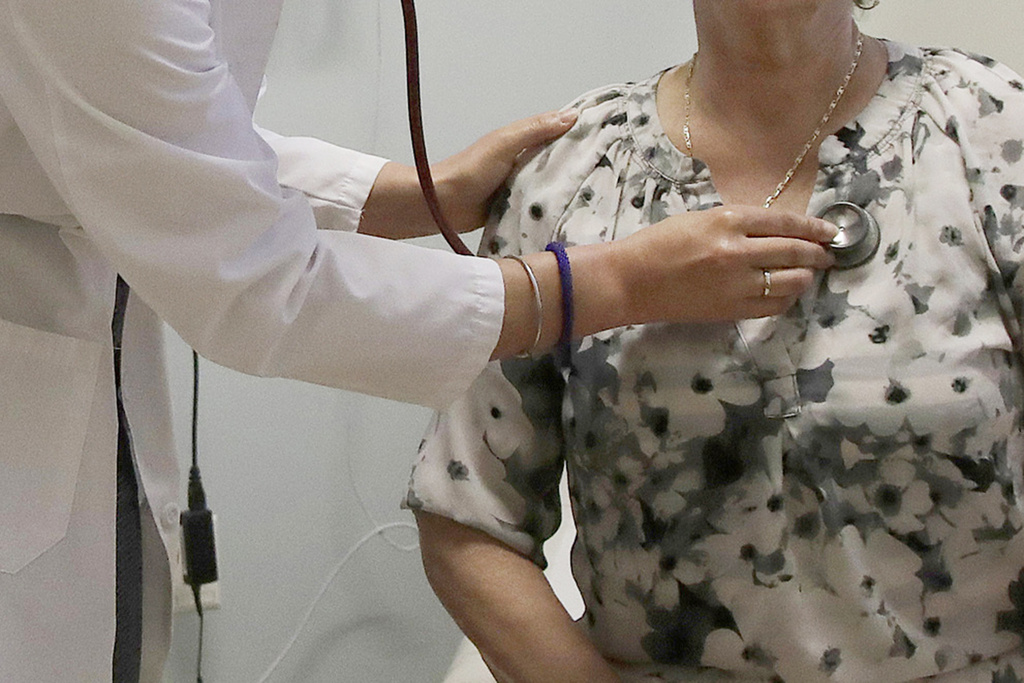 A doctor examines a patient at a clinic in Stanford, Calif.
