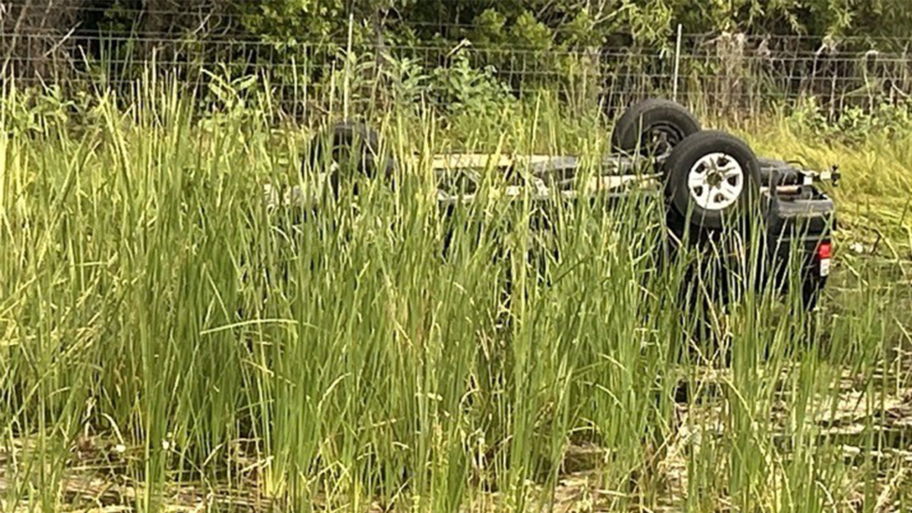 A car flipped over into a canal on the side of Interstate 95 southbound at Bridge Road, west of Hobe Sound, on Aug. 16, 2024.jpg